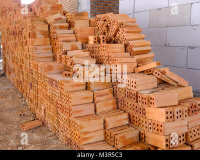 Pile of red bricks which is prepared for construction Stock Photo