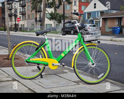 LimeBike's (bicycle-sharing company) green bicycle parked on a street in Bothell WA, in February 2018 Stock Photo