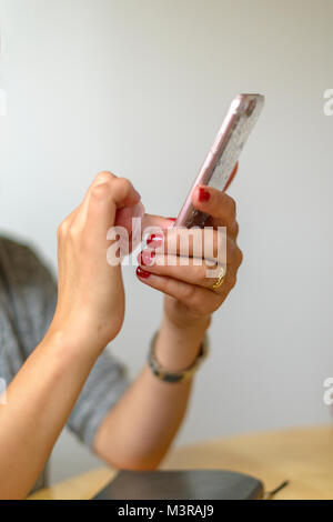 Close-up of a woman on touch screen mobile phone Stock Photo