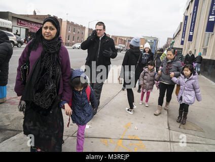 Parents, caregivers and others walk on McDonald Avenue after school in the highly multiethnic and multicultural Kensington neighborhood in Brooklyn, New York. Stock Photo