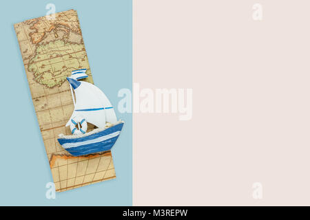 Table top view aerial accessory plan to travel in holiday background concept.Flat lay essential items boat with map on modern blue & white paper.Duo b Stock Photo