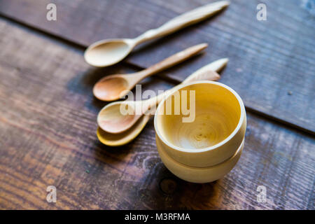Empty wooden bowls and spoons on wooden background Stock Photo