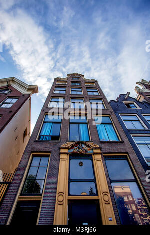 AMSTERDAM, THE NETHERLANDS - JUNE 10, 2014: Beautiful facades of canal buildings in Amsterdam