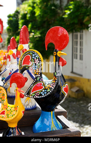 Portuguese symbolic Cockerel ornaments on sale in Obidos village, Portugal Stock Photo