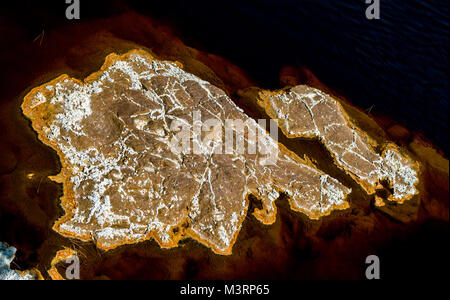 Fantastic colours of Rio Tinto.Odd pattern of minerals covering rocks on the bank of the river. Province Huelva, Andalusia, Spain Stock Photo