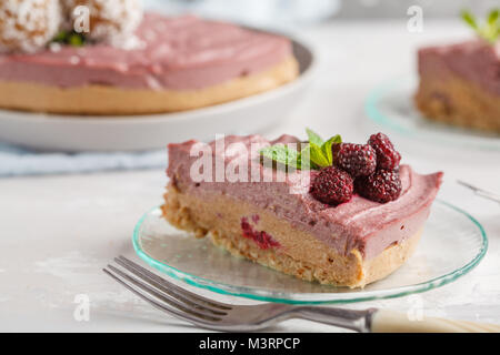 Pink berry caramel raw vegan cheesecake. Healthy vegan food concept. Stock Photo