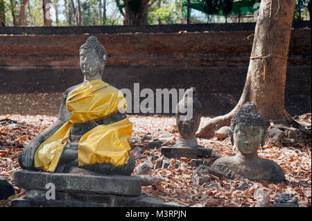 Ancient outdoor Buddhas field of broken sculpture in Wat Umong Suan Puthatham.The temple is a 700 year was built in 1297 in Chiang Mai city,Thailand. Stock Photo