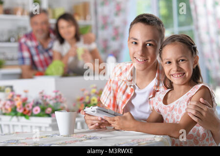 Brother and sister using tablet Stock Photo