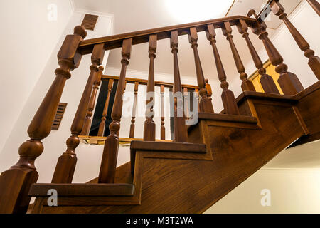Close-up detail of brown wooden oak stairs in new renovated house. Staircase between two floors. Stock Photo