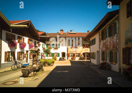 Traditional low-rise residential houses decorated with murals and plants in Mittenwald, Germany Stock Photo