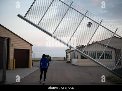 Airman 1st Class Alexandra Ayub, a missile chef, returns to a missile alert facility in Nebraska after a physical training session on the country roads outside the MAF. (U.S. Air Force photo/Staff Sgt. Andrew Lee) 160515-F-NL936-193 by AirmanMagazine Stock Photo