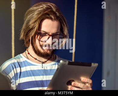 Bearded Man Uses Tablet Stock Photo