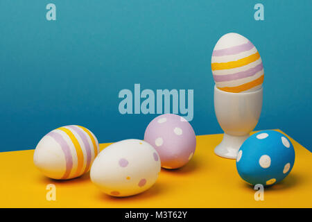 Still-life from Easter eggs on a multi-colored background. Festive subjects close-up Stock Photo
