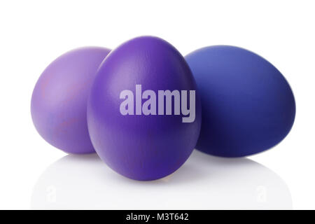 Easter decoration, three chicken eggs painted in purple color isolated on white background Stock Photo