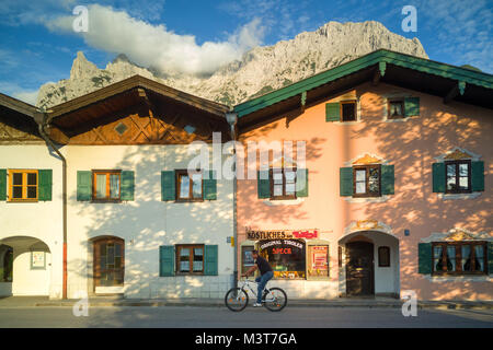 Typical bavarian country houses with distant mountain top and cloud in Mittenwald, Germany Stock Photo