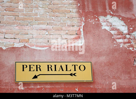 big road sign with the arrow with the indication to reach the famous Rialto bridge in Venice in Italy Stock Photo