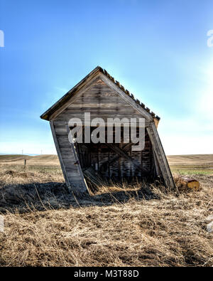 An old shed in eastern Washington is leaning a great deal. Stock Photo