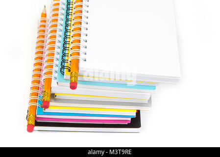 Stack of colorful notebooks with pencils isolated on white Stock Photo