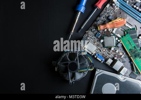 Personal computer motherboard and computer accessories equipment close up on black background with copy space for your text.Technology concept Stock Photo