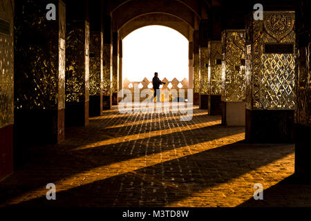 Photographer silhouette and light reflections at sunrise in temple on Mandalay Hill Mandalay Myanmar Stock Photo