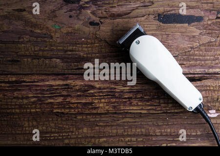 Stylish Professional Barber Clippers, Hair Clippers, Haircut accessories on wood background with copy space Stock Photo