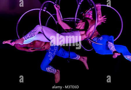 Bitonto, Italy - May 28, 2017: Acrobats perform a trick on slings suspended in the void and secured with harnesses on a festive evening in the main sq Stock Photo