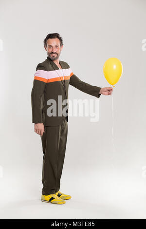 Happy man with yellow balloon Stock Photo