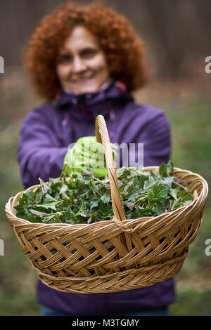 Farmer woman in a field offering colorful organic vegetables as healthy ...