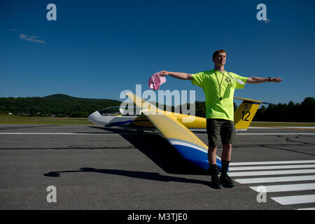 Civil Air Patrol cadet, Jens Houck, uses hand signals for the tow plane to wait for air traffic to clear before taking off in Springfield, Vt. Cadets attending the Northeast Region Glider Academy learn the standard hand signals used in glider ground operations. (U.S. Air Force photo/Master Sgt. Jeffrey Allen) DSC 3459 by AirmanMagazine Stock Photo