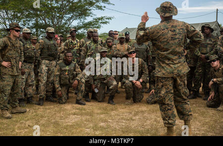 Lance Cpl. Jackson Clark, military policeman with 4th Law Enforcement Battalion teaches a class about how to load and operate the M32 grenade launcher during Exercise Tradewinds 2016, at Twickenham Park Gallery Range, Jamaica, June 24, 2016. Tradewinds is designed to conduct joint, combined and interagency participating nation capacity building focuses on increasing regional cooperation in complex multinational security operations and humanitarian assistance. (U.S. Marine Corps photo by Cpl. Justin T. Updegraff/ Released) 160624-M-TV331-059 by ussouthcom Stock Photo