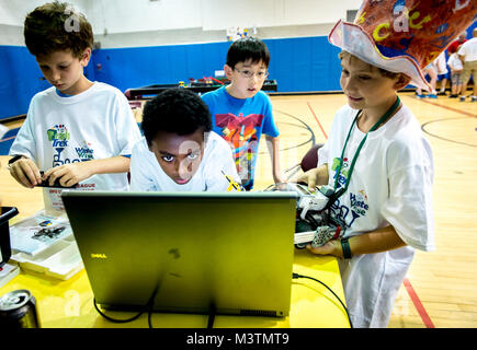 Zachary Shockey, 10, Samson Scheie, 12, Lance Zhang, 10, and Samuel Snowden, 9, program their robot during a First Lego League tournament at the DoD Starbase building near the Air Force Research Laboratory at Wright Patterson Air Force Base in Dayton, Ohio, Jul 22, 2016. The Air Force STEM outreach offices work with the First Lego League, which teaches young students how to build and program robots made of Legos, to not only support STEM education, but also to make young technical minds aware of opportunities to pursue science in the U.S. Air Force.  (U.S. Air Force photo by J.M. Eddins Jr.) 1 Stock Photo
