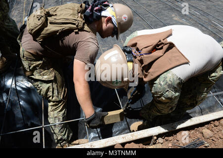 CONCHAGUA, El Salvador (Aug. 16, 2016) – Builder Second Class Thomas Rambo and Construction Electrician Third Class Bryan Terrazas, both assigned to Navy Mobile Construction Unit 133, space and tie rebar in preparation for pouring the foundation of a new community center during Southern Partnership Station 2016 (SPS-16).  SPS-16 is an annual series of U.S. Navy deployments, fostering a lasting relationship with the people of Central and South America through exercises, operations and community relations projects. (U.S. Navy photo by Mass Communication Specialist 1st Class Kimberly Clifford/Rel Stock Photo