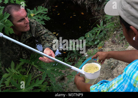 CHOLOMA, Honduras (Aug. 17, 2016) – U.S. Navy Hospital Corpsman 1st Class Michael Bigelow, a preventive medicine technician assigned to Naval Environmental Preventive Medicine Unit 2, gives a water sample to Xenia Caballero, a member of Operation Blessing, during Southern Partnership Station 2016 (SPS-16). SPS-16 is an annual series of U.S. Navy deployments focused on subject matter expert exchanges with partner nation militaries and security forces in Central and South America and the Caribbean. U.S. military teams work with partner nation forces during naval-focused training exercises, milit Stock Photo