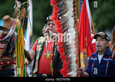 Vietnam War Native American Veteran and Oneida Health and Safety Coordinator, Mr. Daniel King, prepares himself and others for the Formal Grand Entry ceremony during the 2nd Annual National Gathering of American Indian Veterans.  The event was held at Cantigny Park located in Wheaton, Illinois 19-21 August 2016.  The event celebrated the long and proud history of Native Americans’ service to the United States Military and honors all veterans American Indian style.   (DoD photo by Marvin Lynchard) 160820-D-FW736-015 by DoD News Photos Stock Photo