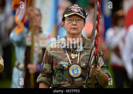 With KIA/MIA POW Veteran Memorial Eagle Staff in hand, Native American Indian Veteran, First Nations Women Warriors, Dr. Judy Peters, performs in the Formal Grand Entry ceremony during the 2nd Annual National Gathering of American Indian Veterans.  The event was held at Cantigny Park located in Wheaton, Illinois 19-21 August 2016.  The event celebrated the long and proud history of Native Americans’ service to the United States Military and honors all veterans American Indian style.   (DoD photo by Marvin Lynchard) 160820-D-FW736-026 by DoD News Photos Stock Photo