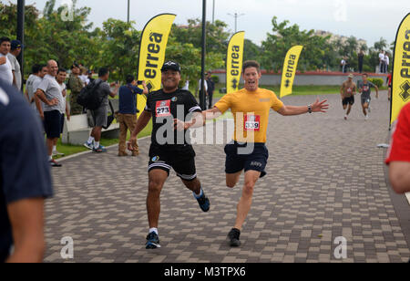 PANAMA CITY, Panama (Sept. 20, 2016) - Chief Boatswain's Mate Justin Noelke, a Sailor assigned to USNS Spearhead (T-EPF-1), encourages a Mexican UNITAS partner nation member during a fun run at the Estadio Maracaná de Panamá soccer stadium. UNITAS is an annual multi-national exercise that focuses on strengthening our existing regional partnerships and encourages establishing new relationships through the exchange of maritime mission-focused knowledge and expertise throughout the exercise. (U.S. Navy Photo by Mass Communication Specialist 1st Class Jacob Sippel/RELEASED) 160920-N-AW702-003 by U Stock Photo