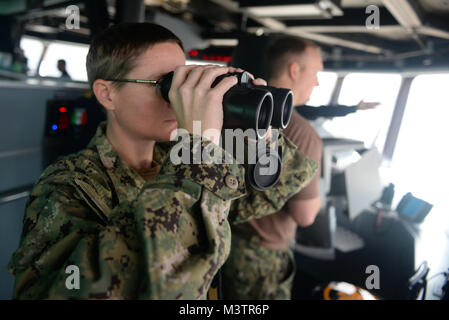 GULF OF PANAMA (Sept. 23, 2016) - Lt. Cmdr. Casey Matthews from Destroyer Squadron 40 looks at ship formations from the bridge of USNS Spearhead (T-EPF 1) during UNITAS 2016. UNITAS is an annual multi-national exercise that focuses on strengthening our existing regional partnerships and encourages establishing new relationships through the exchange of maritime mission-focused knowledge and expertise throughout the exercise. (U.S. Navy Photo by Mass Communication Specialist 1st Class Jacob Sippel/RELEASED) 160923-N-AW702-001 by U.S. Naval Forces Southern Command  U.S. 4th Fleet Stock Photo