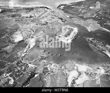 Aerial view of the U.S. Naval Operating Base, Pearl Harbor, Oahu, Hawaii (USA), looking southwest on 30 October 1941. Ford Island Naval Air Station is in the center, with the Pearl Harbor Navy Yard just beyond it, across the channel. The airfield in the upper left-center is the U.S. Army's Hickam Field. Pearl Harbor looking southwest-Oct41 by AirmanMagazine Stock Photo