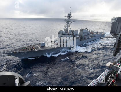 PACIFIC OCEAN (Oct. 16, 2016) – The Arleigh Burke-class guided-missile destroyer USS Chafee (DDG 90) pulls alongside the aircraft carrier USS Nimitz (CVN 68) for a scheduled replenishment at sea. Nimitz is underway to complete flight deck certification and carrier qualifications for an upcoming 2017 deployment. (U.S. Navy photo by Seaman Weston A. Mohr/Released) 161016-N-UM507-033 by USS NIMITZ (CVN 68) Stock Photo