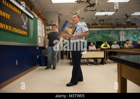 Staff Sgt. Geoffrey Moshier, 311th Air Force Recruiting Station, Pittsburgh, Pa., plays a cost-comparison game with JROTC students at North Allegheny High School, Wexford, Pa., Dec. 5, 2016. The game illustrates the advantage that military service members have by enlisting immediately after high school versus joining after college and having to pay back student loans. (U.S. Air Force photo by/Tech Sgt. Vernon Young Jr.) 161205-F-IO684-026 by AirmanMagazine Stock Photo