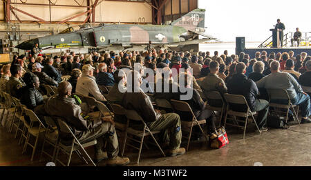 Former McDonnell Douglas F-4 Phantom II pilots and other visitors listen to the remarks of Lt. Col. Ron 'Elvis' King, commander of the 82nd Aerial Target Squadron Detachment 1 during a retirement ceremony following the final military flight of the storied Phantom at Holloman AFB, N.M., Dec. 21, 2016. The F-4 Phantom II entered the U.S. Air Force inventory in 1963 and was the primary multi-role aircraft in the USAF throughout the 1960s and 1970s. The F-4 flew bombing, combat air patrol, fighter escort, reconnaissance and the famous Wild Weasel anti-aircraft missile suppression missions. King wa Stock Photo