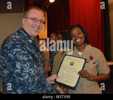 170208-N-SP496-014 SILVERDALE, Wash. (Feb. 8, 2017) – Capt. Alan Schrader, Naval Base Kitsap (NBK) commanding officer, presents Electronics Technician 2nd Class Cierra Staples with the Good Conduct Medal during an all-hands call held at the NBK-Bangor Theater. More than 30 awards and decorations were bestowed to NBK personnel during the event. (U.S. Navy photo by Petty Officer 3rd Class Jane Wood/Released) 170208-N-SP496-014 by Naval Base Kitsap (NBK) Stock Photo