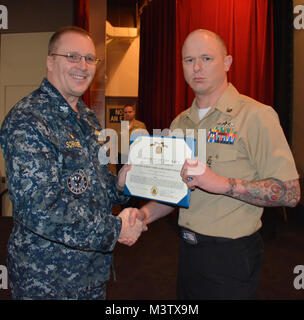 170208-N-SP496-023 SILVERDALE, Wash. (Feb. 8, 2017) – Capt. Alan Schrader (left), Naval Base Kitsap (NBK) commanding officer, presents Culinary Specialist 1st Class Pete Kowall with the Navy and Marine Corps Achievement Medal during an all-hands call held at the NBK-Bangor Theater. More than 30 awards and decorations were bestowed to NBK personnel during the event. (U.S. Navy photo by Petty Officer 3rd Class Jane Wood/Released) 170208-N-SP496-023 by Naval Base Kitsap (NBK) Stock Photo