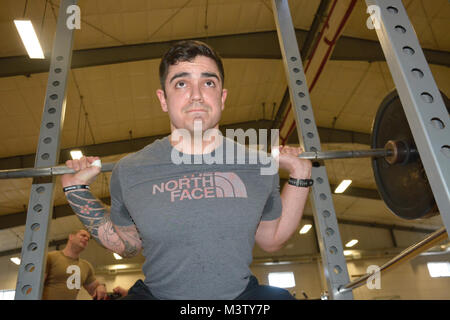 170228-N-DA597-005 SILVERDALE, Wash. (Feb. 28, 2017) – Machinist Mate 1st Class Nick Wheeler gives a back squat demonstration on the new Navy Operational Fitness and Fueling Systems (NOFFS) gym equipment at Naval Base Kitsap (NBK) – Bangor. (U.S. Navy photo by Petty Officer 2nd Class Athena Barber/Released) 170228-N-DA597-005 by Naval Base Kitsap (NBK) Stock Photo