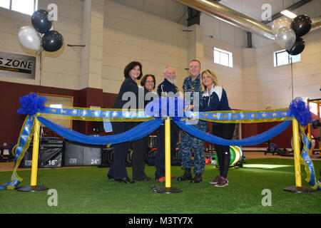 170228-N-DA597-010 SILVERDALE, Wash. (Feb 28, 2017) – Capt. Alan Schrader (third from the right), Naval Base Kitsap (NBK) commanding officer, and the Navy Operational Fitness and Fueling Systems (NOFFS) facility staff prepare to cut the ribbon, commemorating the newest addition to NBK’s mission for fitness. (U.S. Navy photo by Petty Officer 2nd Class Athena Barber/Released) NOFFS Ribbon Cutting by Naval Base Kitsap (NBK) Stock Photo