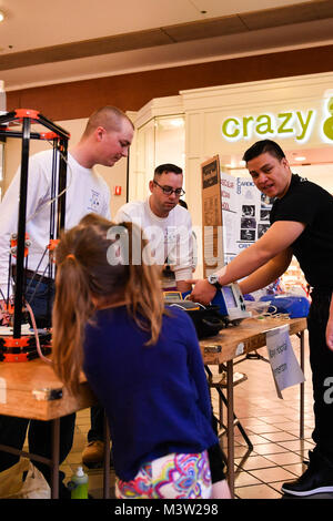 170422-N-SH284-030 SILVERDALE, Wash. (April 22, 2017) Hospital Corpsman 1st Class Nick Behel (left), Hospital Corpsman 1st Class Mike Bindner (center) and Hospital Corpsman 3rd Class Kevin Hill, all assigned to Naval Hospital Bremerton, demonstrate an Automated External Defibrillator for children at the annual West Sound STEM Showcase at the Kitsap Mall. Each year the Showcase presents science, technology, engineering & math (STEM) principles at a fun, interactive event. The Showcase included more than 60 booths, hosted by dozens of area organizations, showcasing hands-on activities to engage  Stock Photo