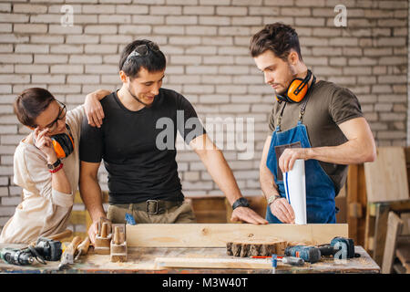 carpenter with students in woodworking workshop Stock Photo
