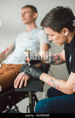 Master of tattoo fill circuit tattoo. Stock Photo