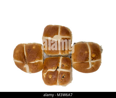 Four freshly baked hotcross buns in the shape of a cross and laid against a white background. Stock Photo