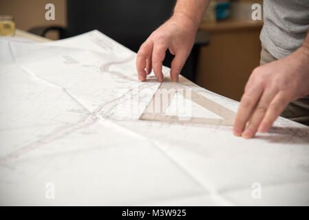 Project checking, man using a ruler for measurement Stock Photo